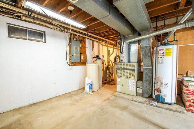 basement featuring gas water heater and electric panel