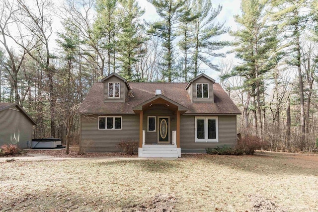 cape cod house featuring a hot tub