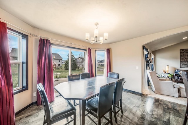 dining area featuring a chandelier, a wealth of natural light, and wood-type flooring