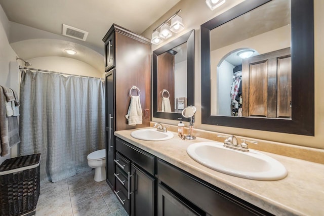 bathroom with tile patterned flooring, vanity, and toilet