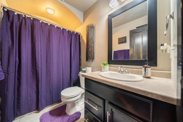 bathroom featuring tile patterned floors, vanity, and toilet