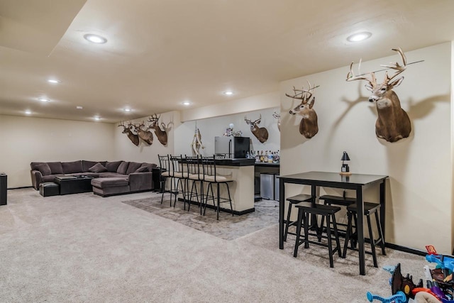 living room with light colored carpet and bar