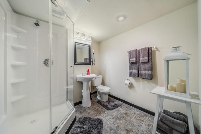 bathroom featuring sink, toilet, and walk in shower