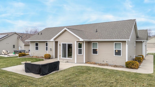 back of house with a patio area and a lawn