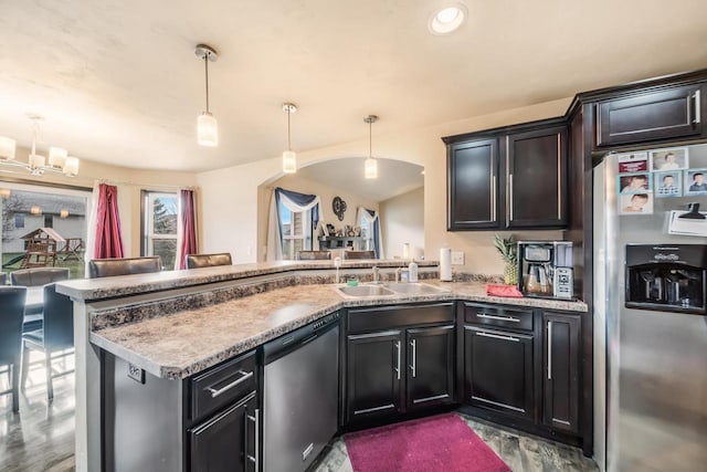 kitchen featuring pendant lighting, sink, kitchen peninsula, and stainless steel appliances