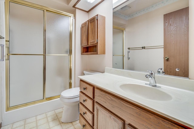 bathroom featuring vanity, toilet, and walk in shower