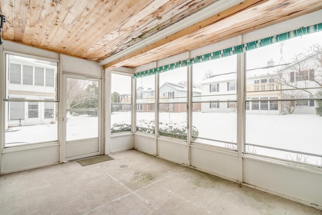 unfurnished sunroom with wooden ceiling