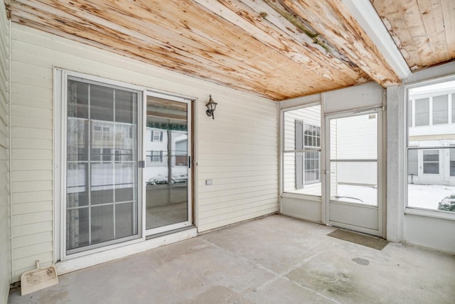 unfurnished sunroom with wooden ceiling