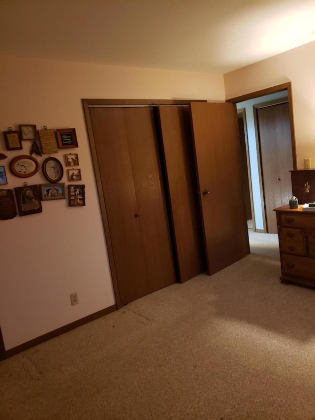 unfurnished bedroom featuring light colored carpet