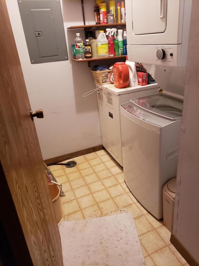 washroom featuring electric panel and stacked washer / dryer