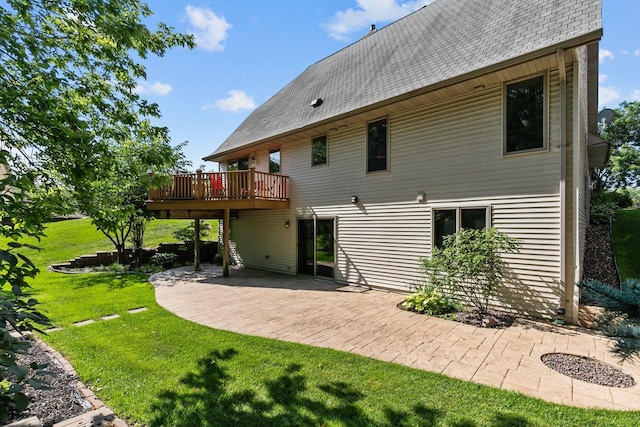 back of house featuring a patio, a deck, and a lawn