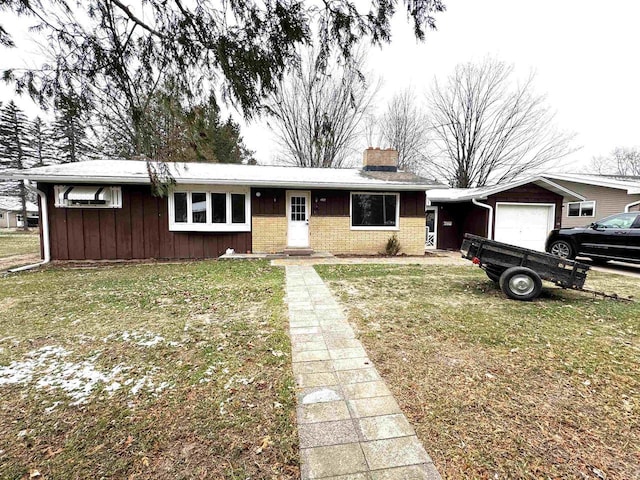 ranch-style house with a garage and a front lawn