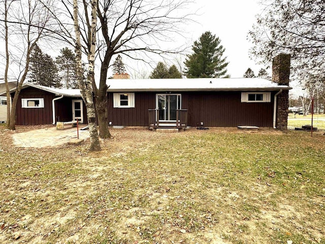 rear view of property featuring a yard