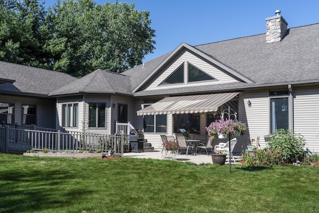 back of house with a yard and a patio