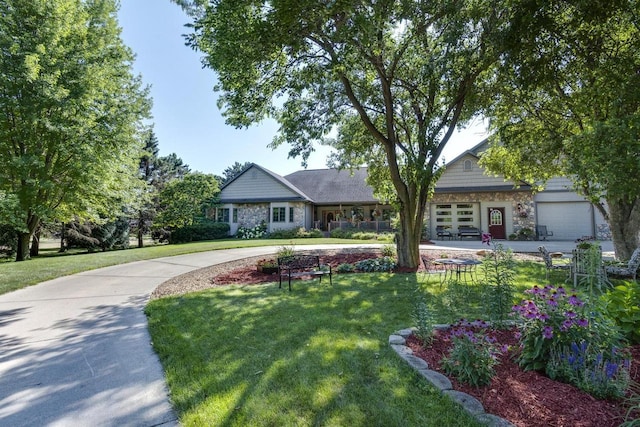 view of front of house with a front yard and a garage