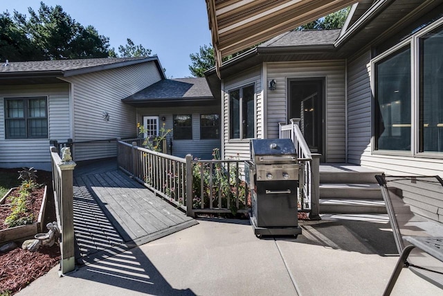 view of patio featuring a grill and a deck