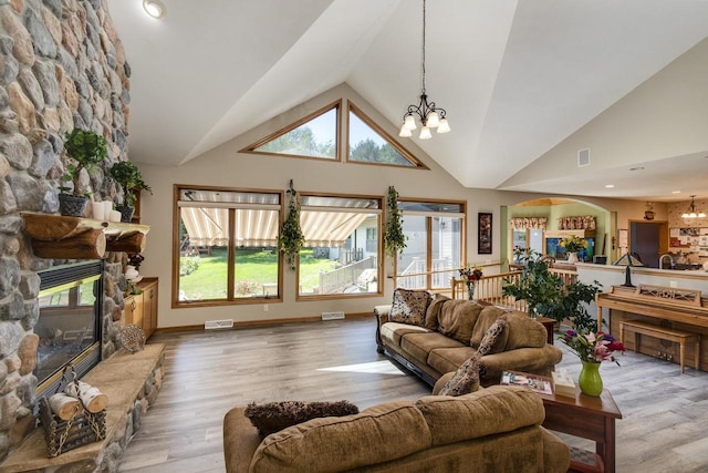 living room with an inviting chandelier, high vaulted ceiling, and a wealth of natural light