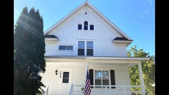 rear view of house featuring covered porch