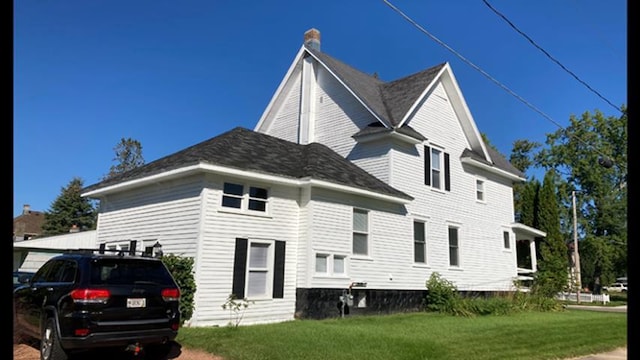 view of side of home featuring a yard