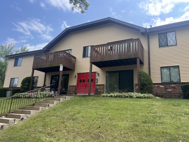 exterior space with a lawn and a balcony