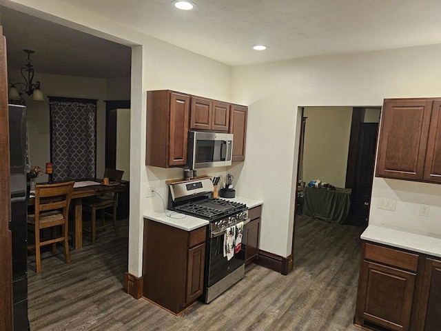 kitchen featuring dark hardwood / wood-style flooring, dark brown cabinetry, and stainless steel appliances