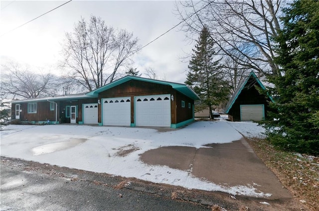 view of snowy exterior with a garage