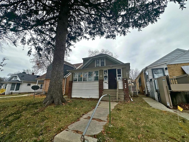 bungalow-style house featuring a front yard