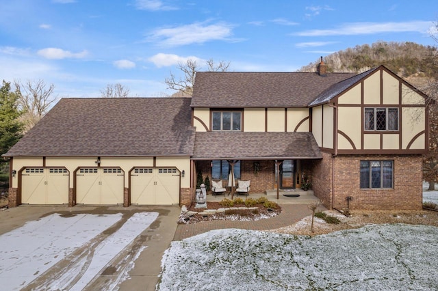 tudor house featuring a garage