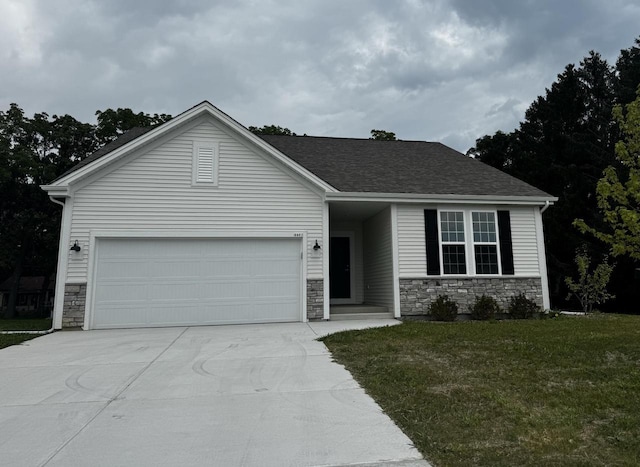 view of front of home with a garage and a front lawn