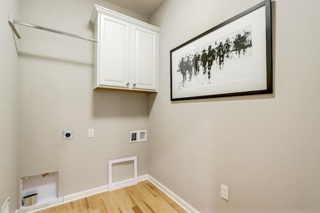 clothes washing area featuring electric dryer hookup, hookup for a washing machine, cabinets, and light wood-type flooring