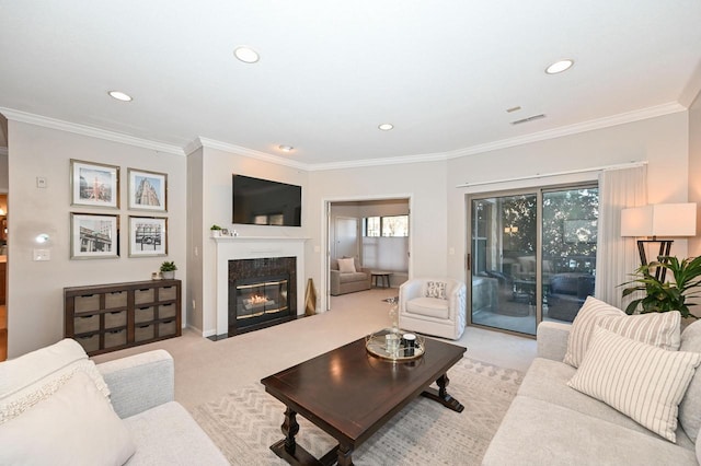 carpeted living room featuring a healthy amount of sunlight, ornamental molding, and a premium fireplace