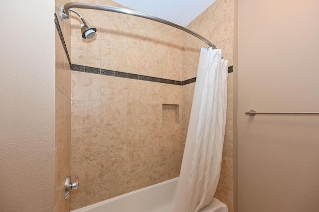 bathroom featuring shower / bathtub combination with curtain