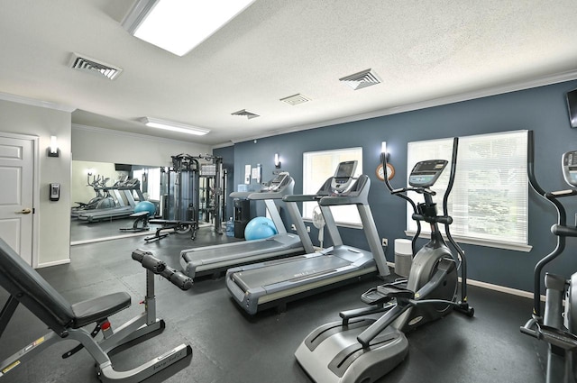 gym with ornamental molding and a textured ceiling