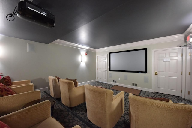 carpeted cinema room with crown molding