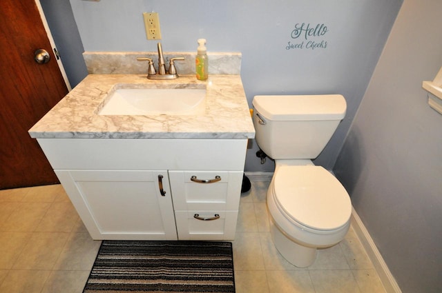 bathroom with vanity, toilet, and tile patterned flooring