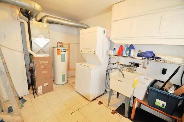 clothes washing area featuring stacked washer / drying machine and electric water heater