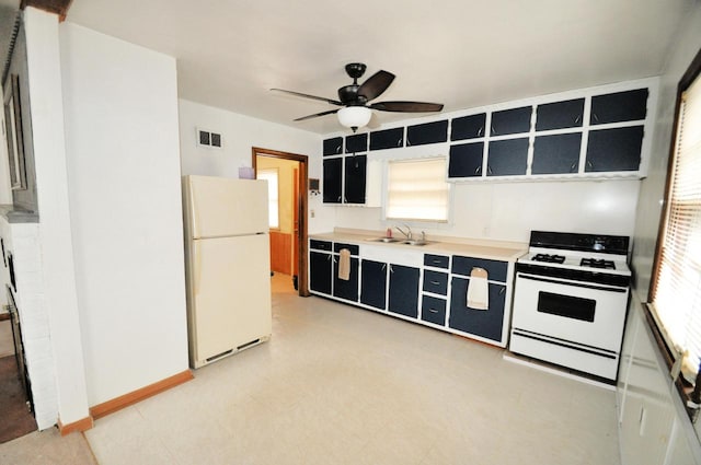 kitchen with sink, white appliances, and ceiling fan