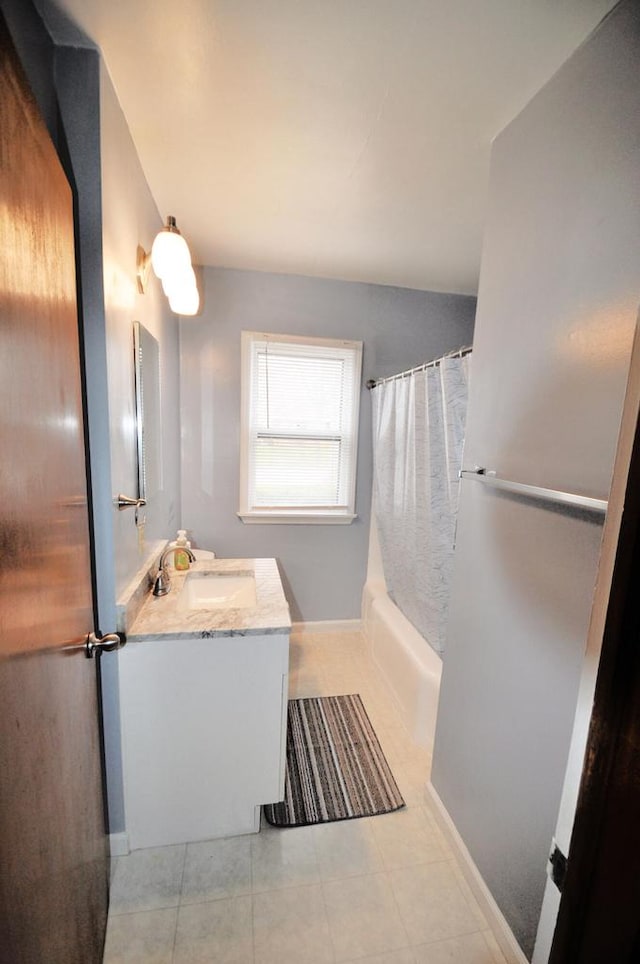 bathroom featuring tile patterned flooring, vanity, and shower / bath combination with curtain