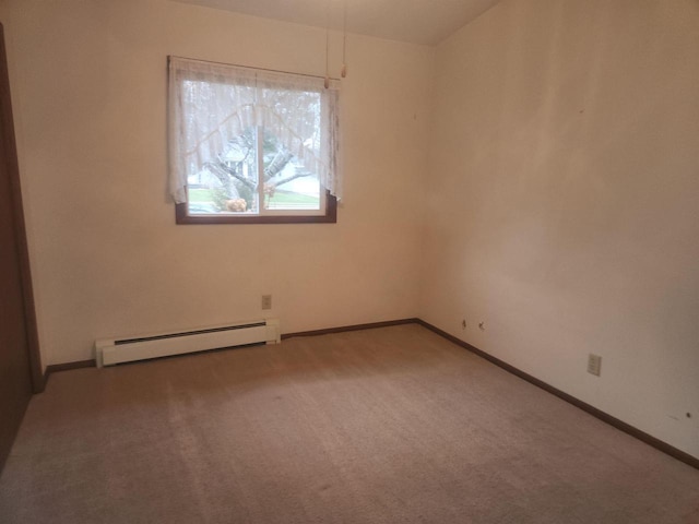 carpeted spare room with baseboard heating