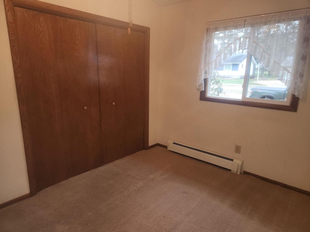 41 E Vista Blvd, Markesan, WI 53946 - unfurnished bedroom with a baseboard heating unit, carpet floors, and a closet