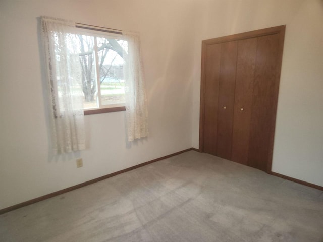 unfurnished bedroom featuring carpet and a closet