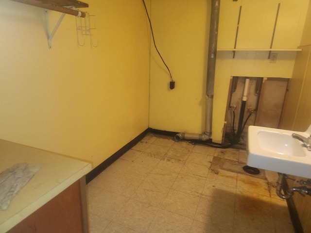 41 E Vista Blvd, Markesan, WI 53946 - basement featuring light flooring, baseboards, and a sink