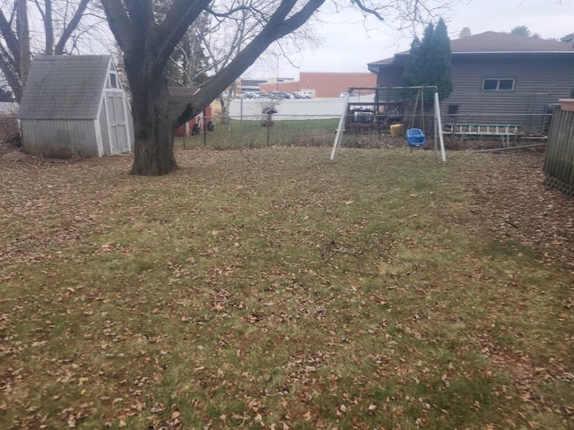 view of yard featuring a playground and a storage shed