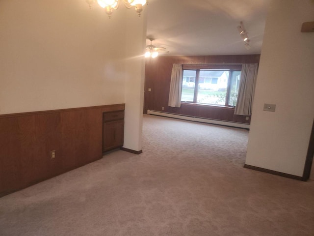 41 E Vista Blvd, Markesan, WI 53946 - spare room featuring a baseboard heating unit, rail lighting, and light carpet