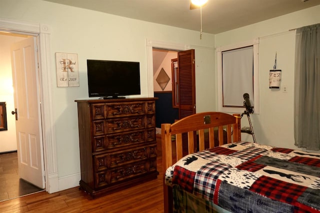 bedroom with dark hardwood / wood-style flooring