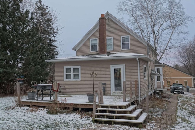 snow covered property featuring a deck