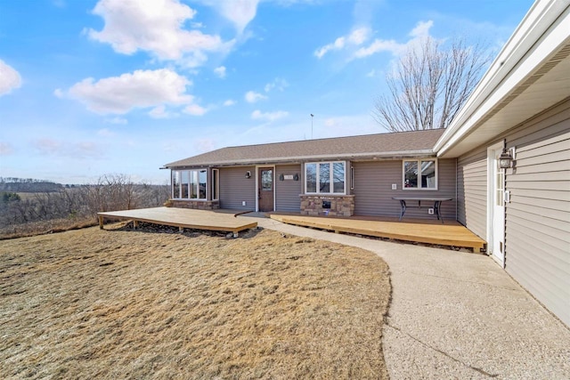 view of front of house with a front yard and a deck