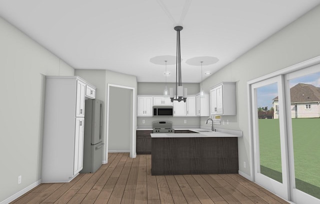 kitchen with sink, hardwood / wood-style floors, decorative light fixtures, white cabinets, and appliances with stainless steel finishes