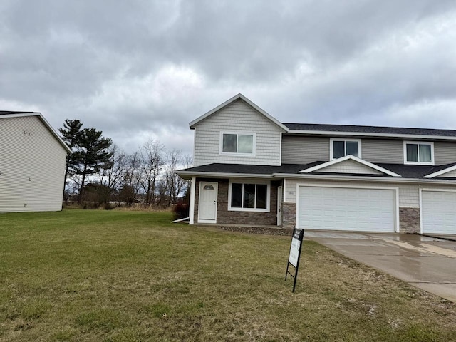 view of front of property featuring a front lawn and a garage