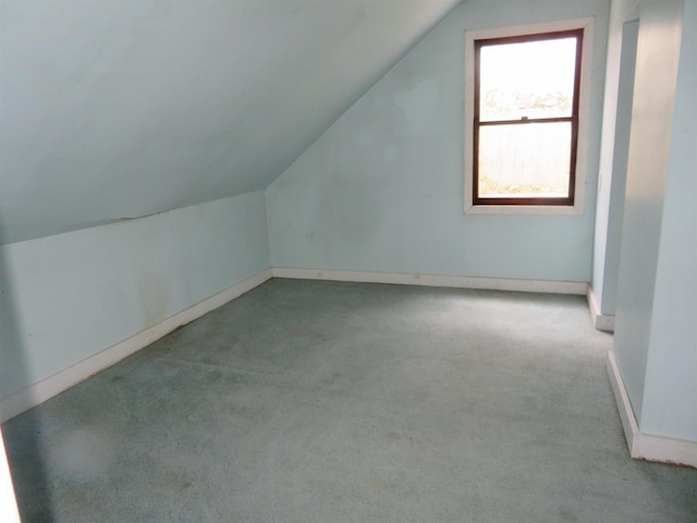 bonus room featuring light colored carpet and vaulted ceiling